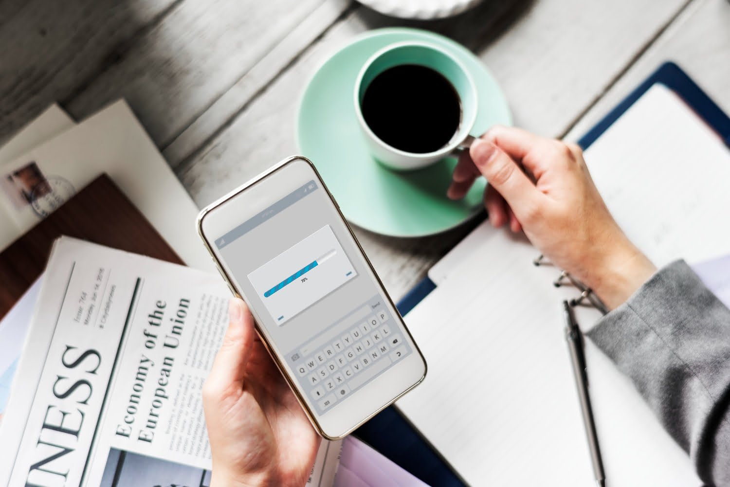 hands-holding-downloading-mobile-phone with coffee cup beverage