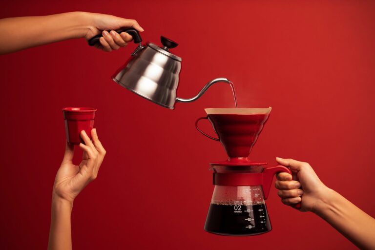 a person pouring hot water on a coffee dispenser